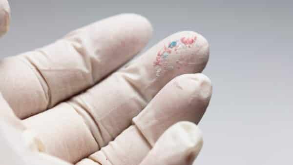 A close-up of microplastic particles, highlighting their environmental and health impacts as physical contaminants of emerging concern (CECs).